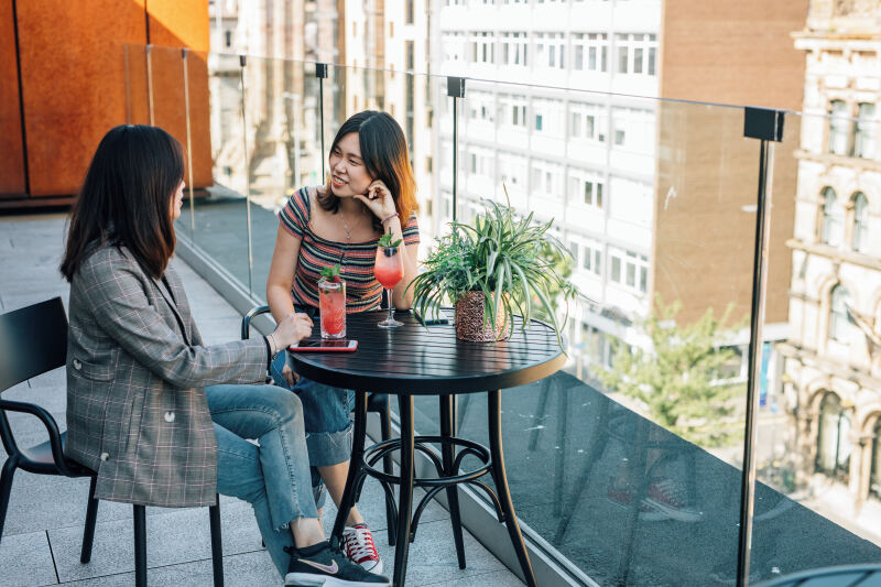 Two female students having a drink on Tetto rooftop bar