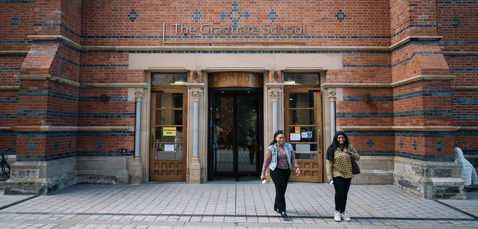 Two students outside the Graduate School