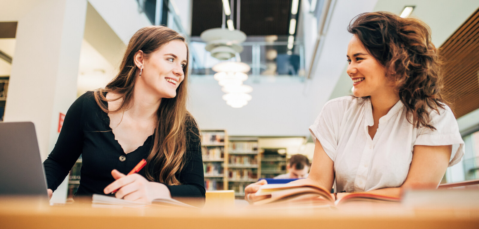 Two students sitting at table in McClay Library