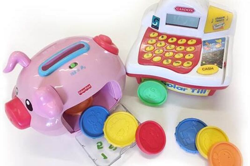 Toy piggy bank, cash register and money