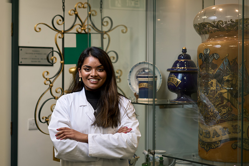 Pharmacist standing in front of pharmacy equipment