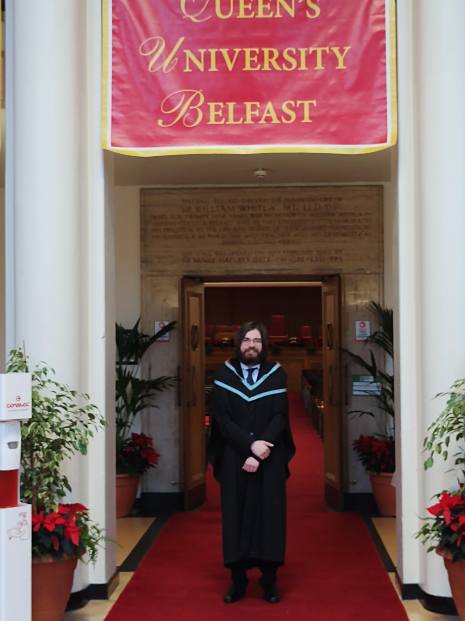 PhD student profile photo, a male student on his graduation day dressed in a gown