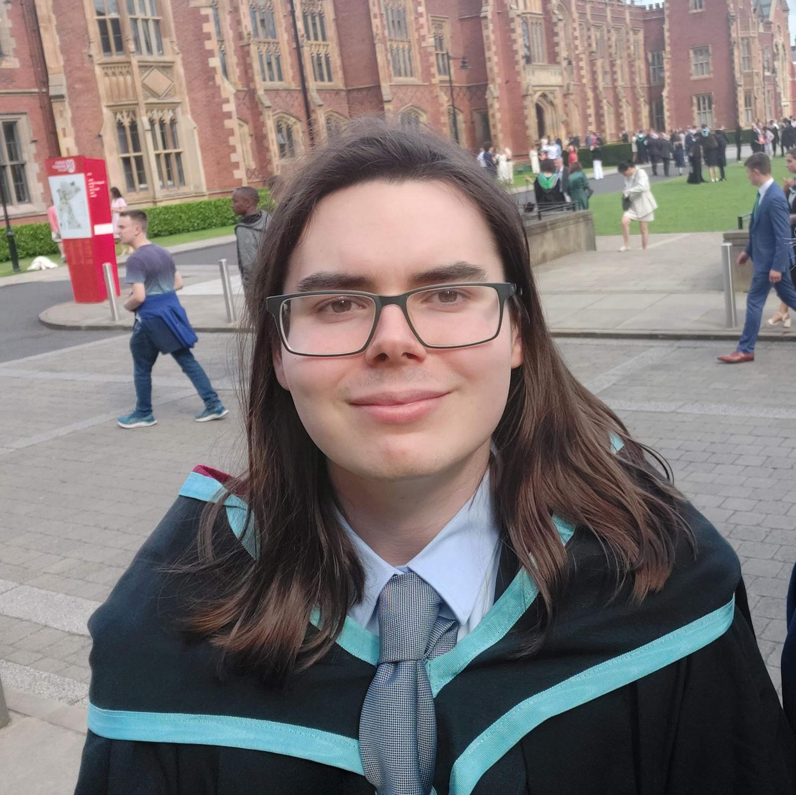 A male student on his graduation day in front of university