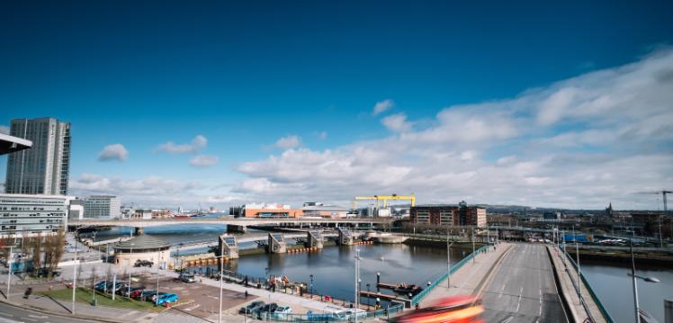 view over bridge and water at Belfast harbour, with yellow cranes in the background