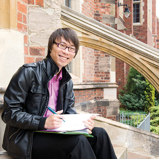 male student sitting on steps