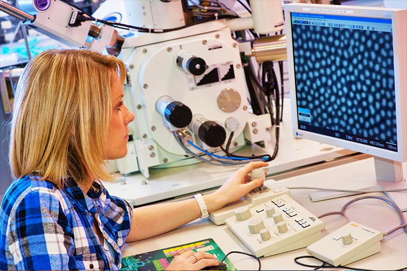 Girl at a computer console examining visual data