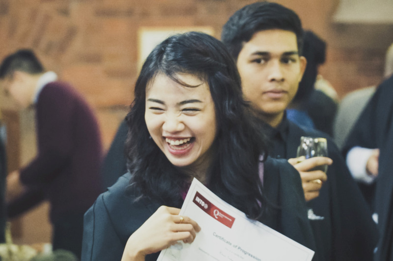 international female student laughing at student welcome event