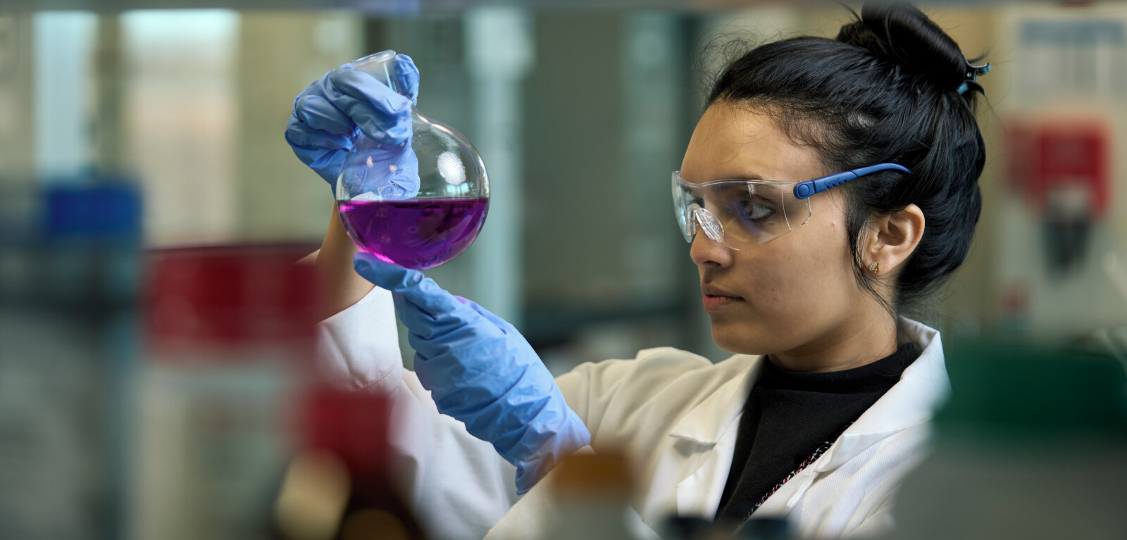 Researcher reviews chemicals in a lab