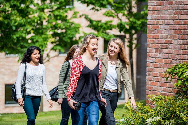 group of female students walking through Elm's village