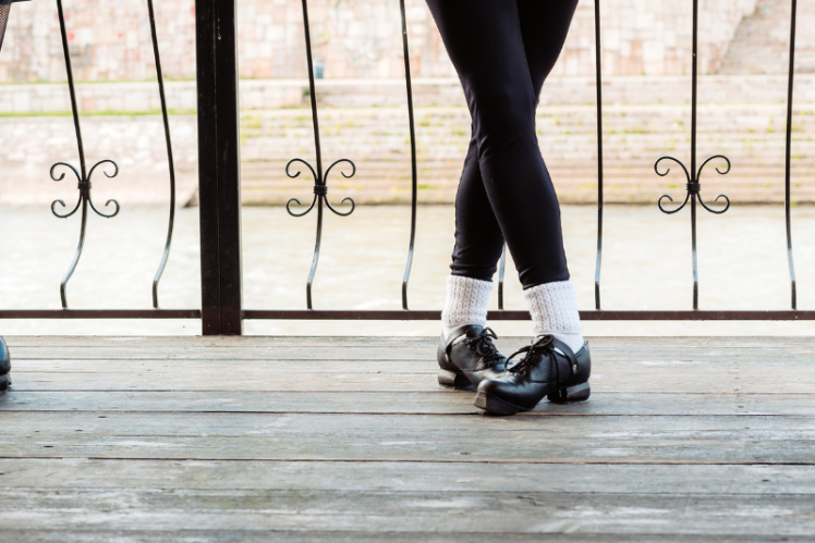 Image shows an Irish dancer's feet in heavy shoes.