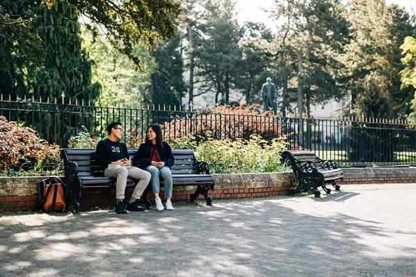 Students seated on a bench outside Botanic Gardens