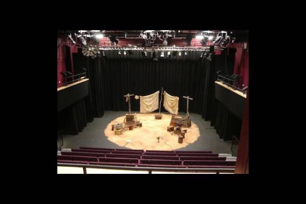 overhead shot of partly set  theatre stage showing lighting rig and seating bank