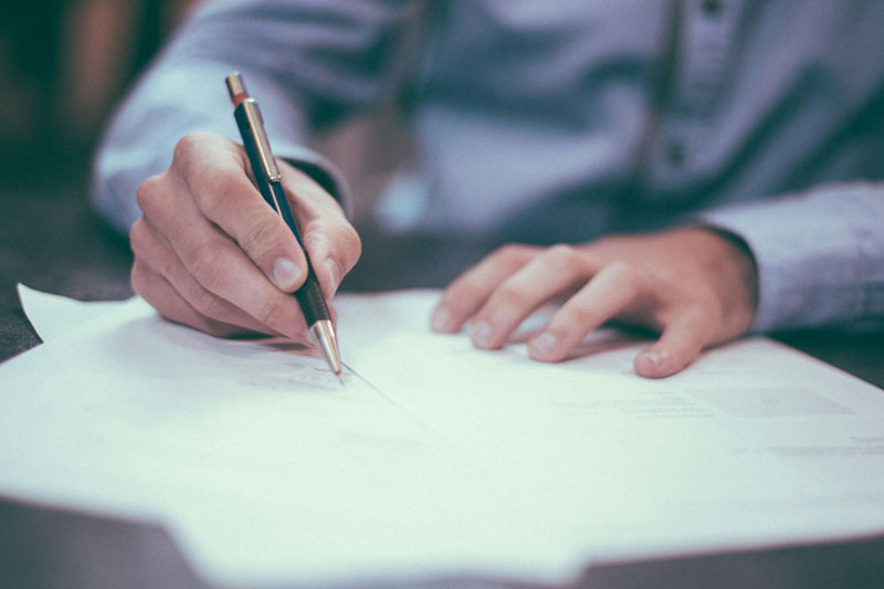 A person signs a document