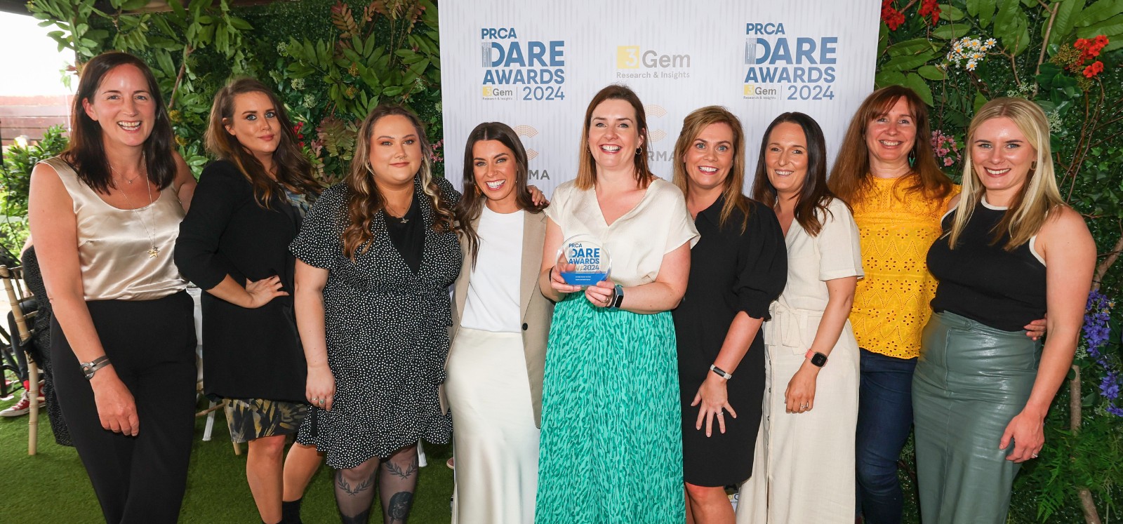 Members of Queen's Strategic Communications Directorate Office celebrating after winning 'In-house Team of the Year' at the PRCA Dare awards, Belfast, 2024