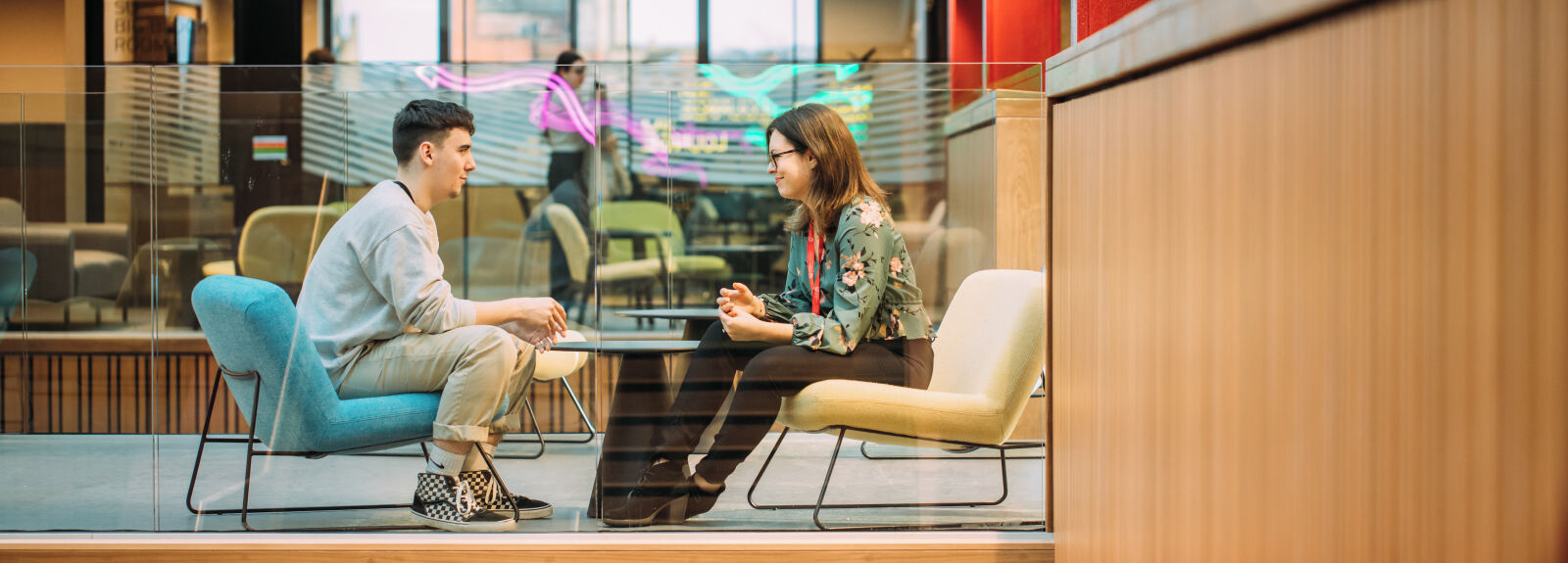 Staff and student talking in One Elmwood building